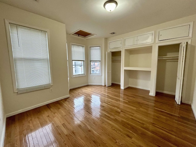 unfurnished bedroom with hardwood / wood-style flooring