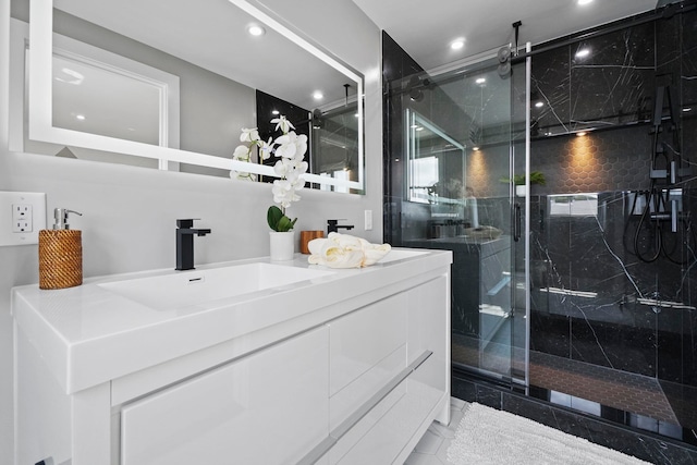 bathroom with vanity, tile patterned flooring, and a shower with door