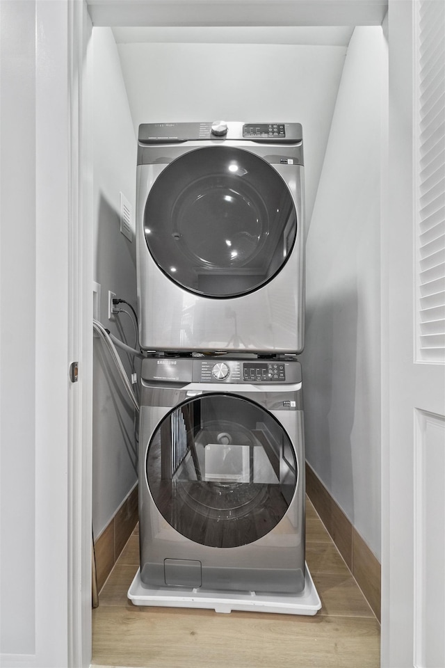 washroom featuring stacked washing maching and dryer