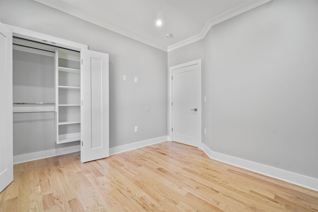 unfurnished bedroom with ornamental molding and light hardwood / wood-style floors