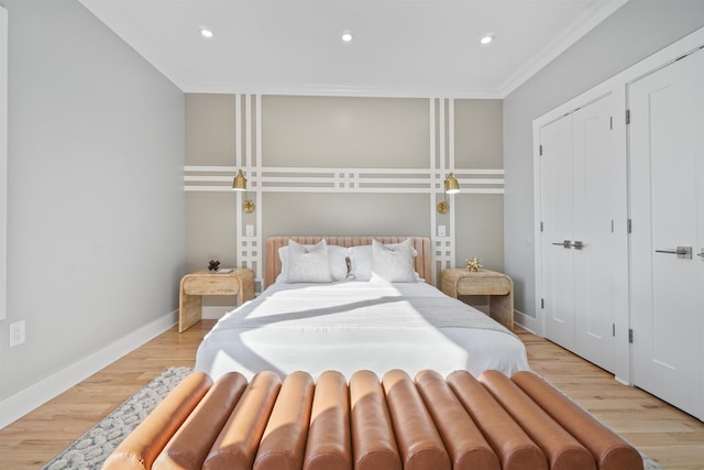 bedroom featuring crown molding, a closet, and light hardwood / wood-style flooring