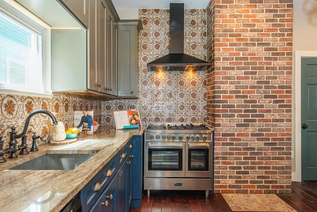 68 Osborne St, Glen Ridge, NJ 07028 - kitchen with wall chimney range hood, double oven range, blue cabinets, light stone countertops, and dark wood finished floors