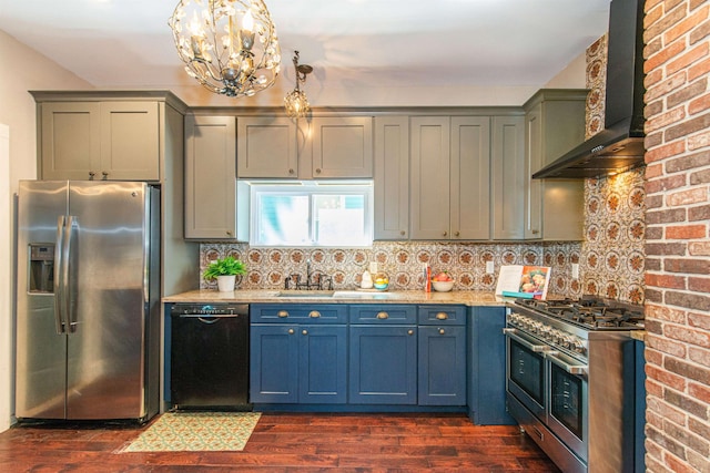 68 Osborne St, Glen Ridge, NJ 07028 - kitchen with appliances with stainless steel finishes, wall chimney range hood, dark wood-type flooring, a chandelier, and backsplash