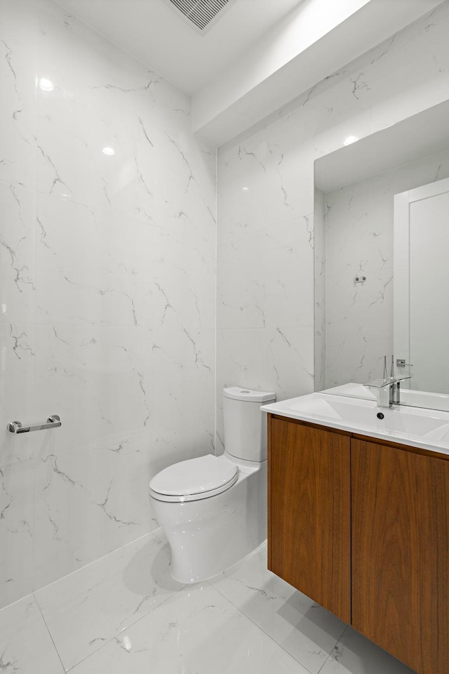 5 Washington Pl, Cliffside Park, NJ 07010 - half bath with marble finish floor, toilet, vanity, and visible vents