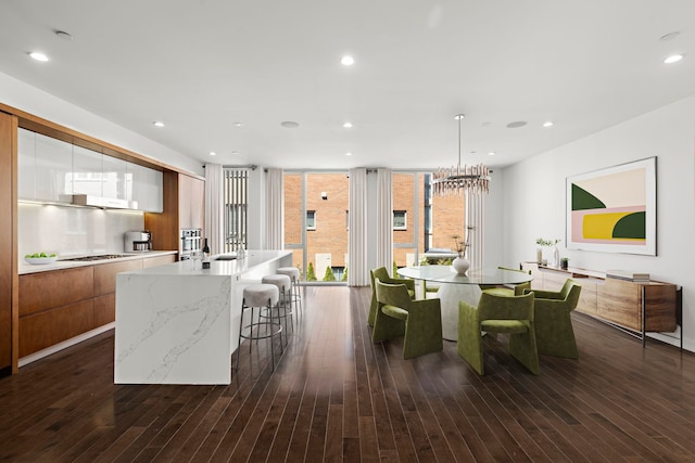 5 Washington Pl, Cliffside Park, NJ 07010 - dining room featuring recessed lighting, a wall of windows, dark wood-style flooring, and an inviting chandelier