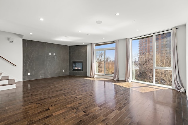 5 Washington Pl, Cliffside Park, NJ 07010 - unfurnished living room featuring a large fireplace, wood finished floors, recessed lighting, and stairs