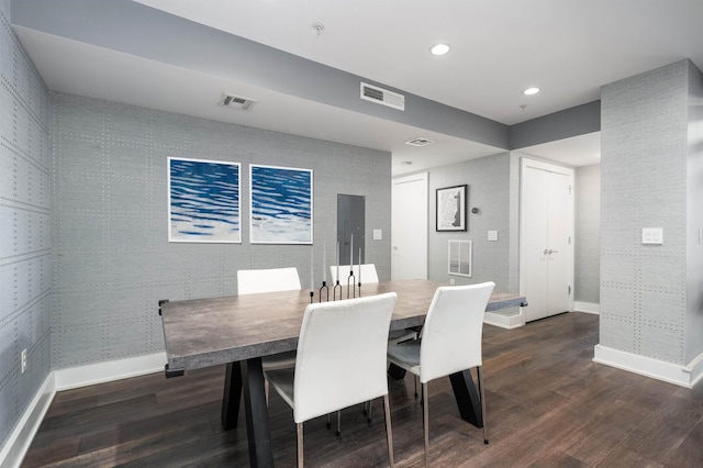 dining space featuring baseboards, wood finished floors, and visible vents