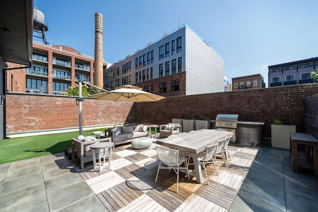 view of patio featuring outdoor lounge area, fence, a grill, outdoor dining area, and area for grilling