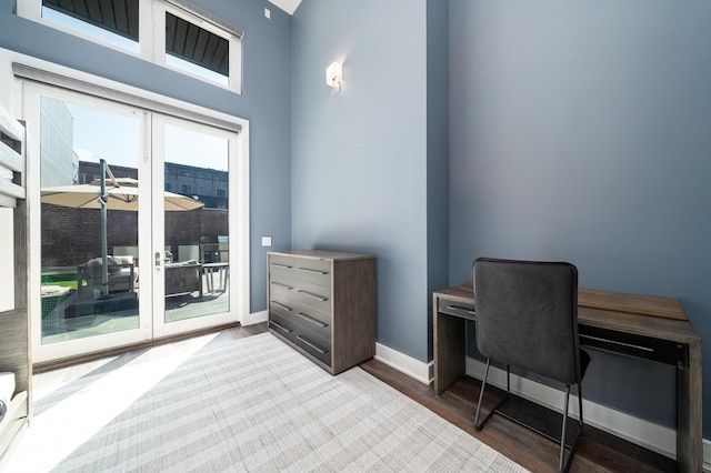 home office featuring baseboards, french doors, and wood finished floors