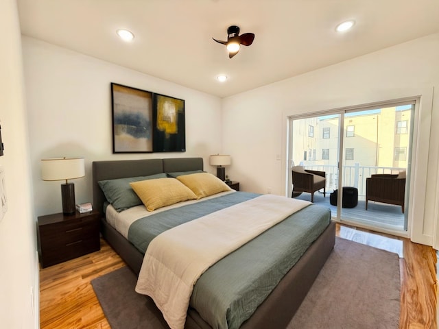 bedroom featuring light wood-type flooring, access to outside, and recessed lighting