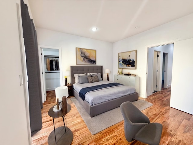 bedroom featuring light wood-type flooring, baseboards, and recessed lighting