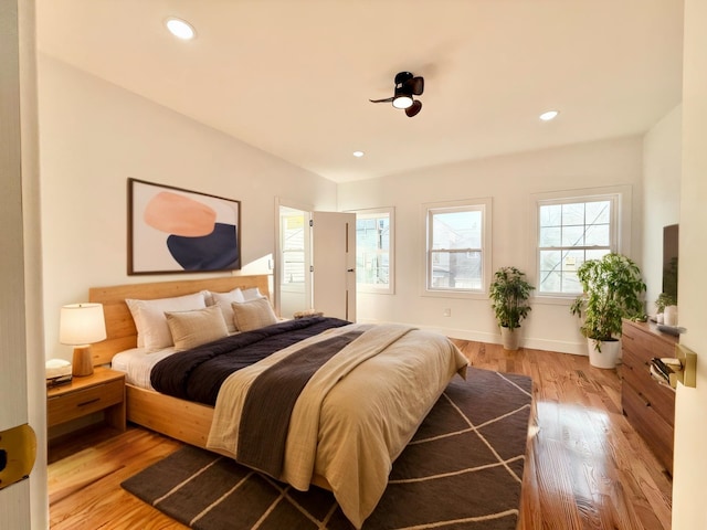 bedroom featuring baseboards, light wood-style flooring, and recessed lighting