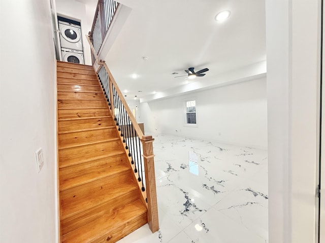 staircase with ceiling fan, marble finish floor, stacked washing maching and dryer, and recessed lighting