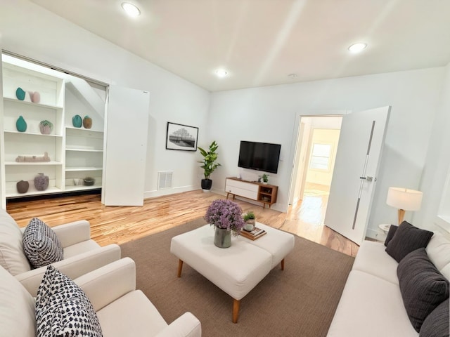 living area featuring wood finished floors, visible vents, and recessed lighting