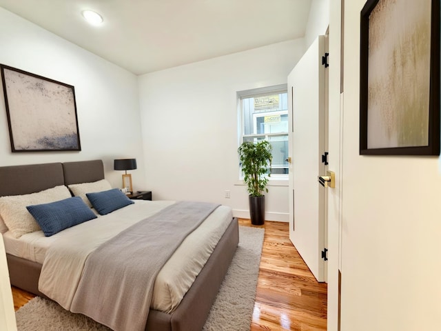 bedroom featuring light wood-type flooring and recessed lighting