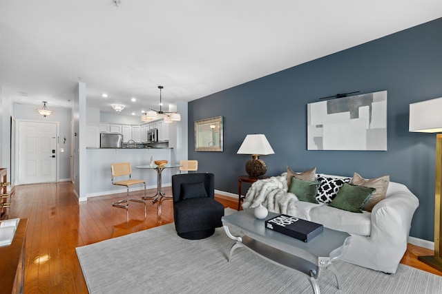 living room with light wood-type flooring and sink