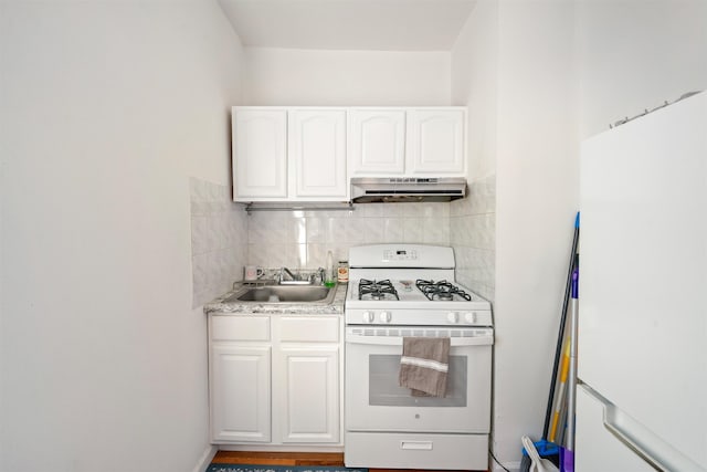 kitchen featuring white range with gas cooktop, sink, white cabinetry, and backsplash