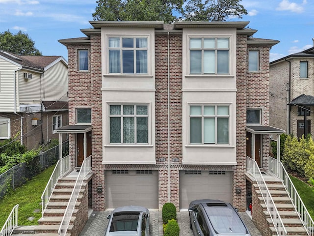405 Commercial Ave, Cliffside Park, NJ 07010 - view of front of house featuring stucco siding, a garage, brick siding, driveway, and stairway