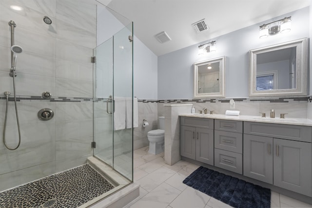 405 Commercial Ave, Cliffside Park, NJ 07010 - bathroom featuring a shower stall, double vanity, marble look tile flooring, and tile walls