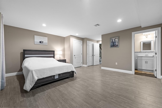 405 Commercial Ave, Cliffside Park, NJ 07010 - bedroom with wood finished floors, multiple closets, recessed lighting, and ensuite bathroom
