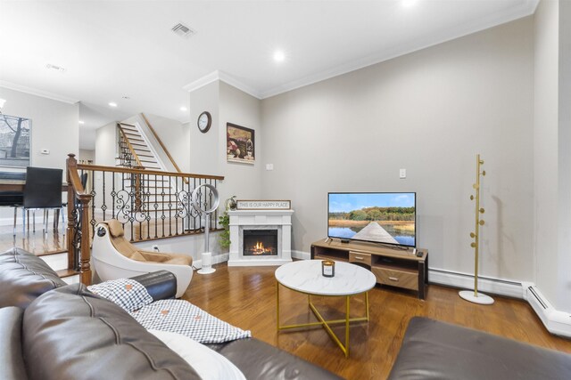 405 Commercial Ave, Cliffside Park, NJ 07010 - living room featuring wood finished floors, ornamental molding, a lit fireplace, recessed lighting, and stairway