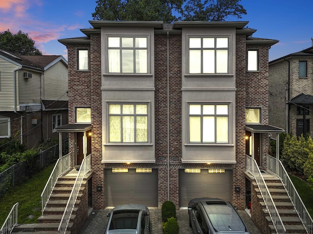 405 Commercial Ave, Cliffside Park, NJ 07010 - contemporary house with an attached garage, brick siding, and stairway