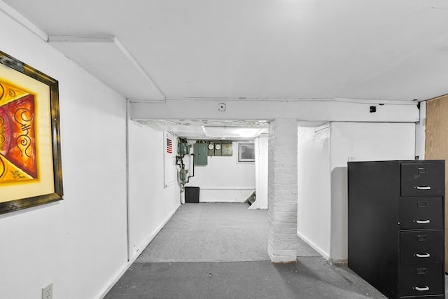 corridor with electric panel and concrete flooring