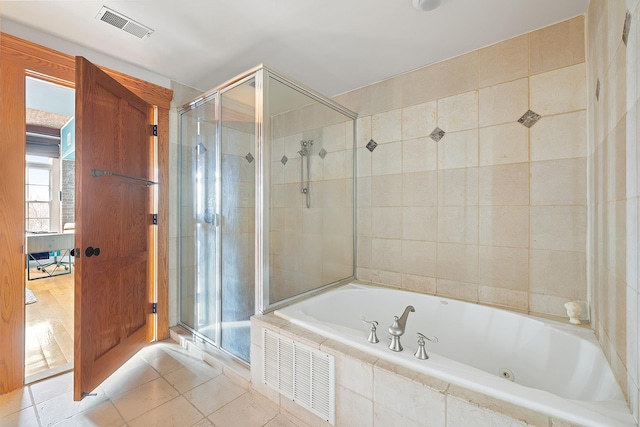 174 Washington St Unit 2K, Jersey City, NJ 07302 - bathroom with a shower stall, a garden tub, and tile patterned floors