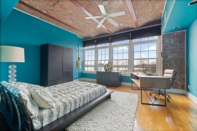 174 Washington St Unit 2K, Jersey City, NJ 07302 - bedroom featuring brick ceiling, baseboards, wood finished floors, and a desk
