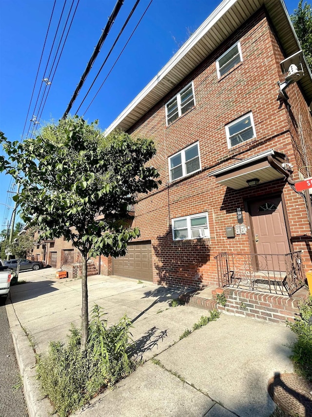 2200 Paterson Plank Rd Unit 25, North Bergen, NJ 07047 - view of property featuring driveway and a garage