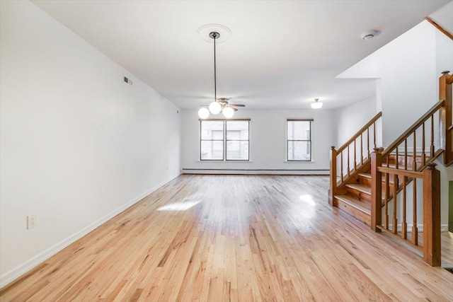 unfurnished living room featuring light wood-type flooring, ceiling fan, and a baseboard radiator