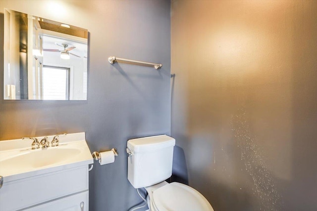 bathroom with ceiling fan, vanity, and toilet