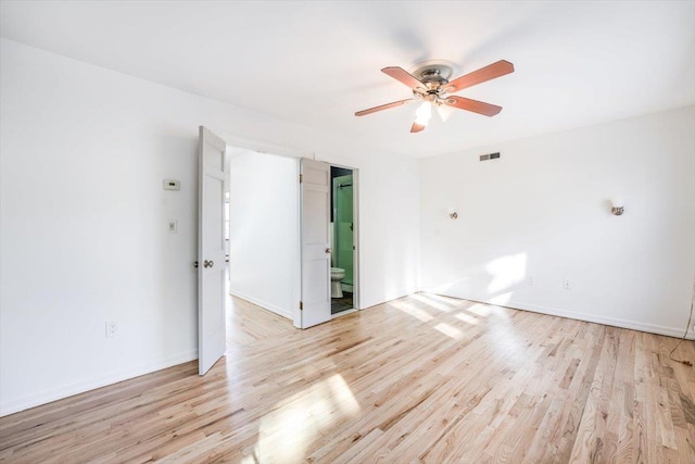 empty room with light hardwood / wood-style floors and ceiling fan