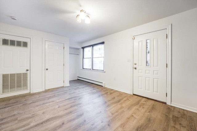 foyer featuring a baseboard radiator and light hardwood / wood-style floors