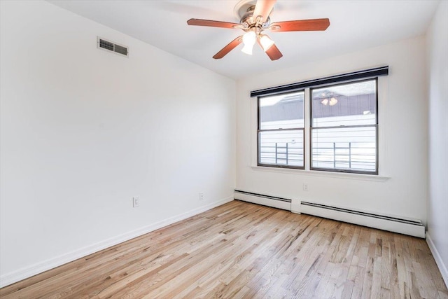 empty room featuring baseboard heating, light wood-type flooring, and ceiling fan