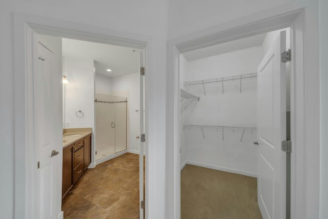 443 2nd St Unit 0212, Jersey City, NJ 07302 - full bathroom with vanity, baseboards, a spacious closet, and a shower stall