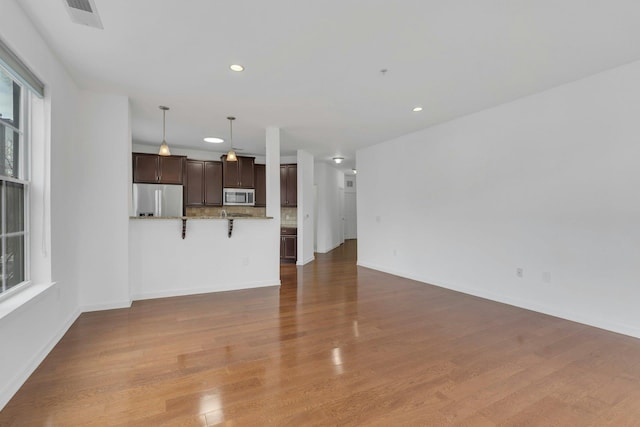 443 2nd St Unit 0212, Jersey City, NJ 07302 - unfurnished living room with recessed lighting, baseboards, visible vents, and wood finished floors