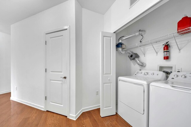 443 2nd St Unit 0212, Jersey City, NJ 07302 - washroom with washer and dryer, laundry area, baseboards, and light wood-type flooring
