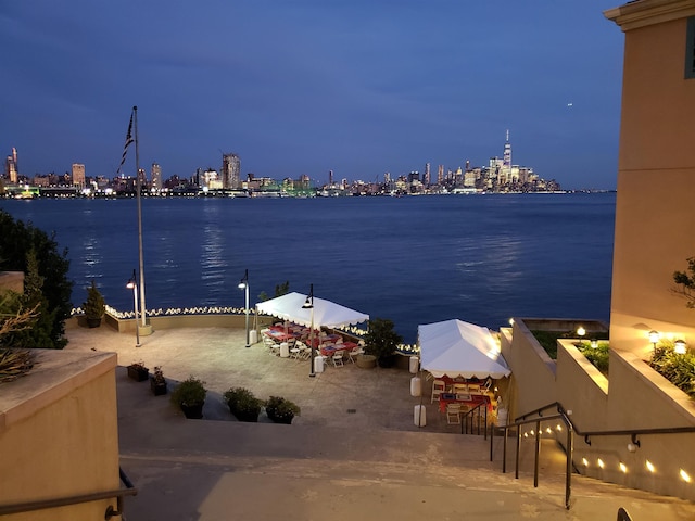 view of water feature featuring a boat dock and a view of city lights