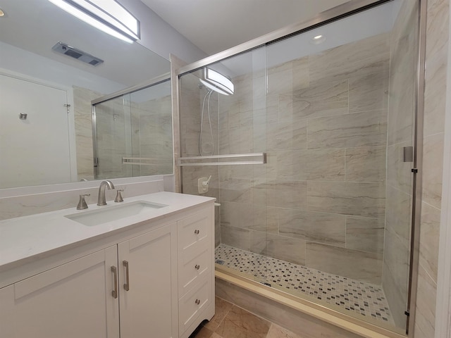 full bath with a stall shower, visible vents, and vanity