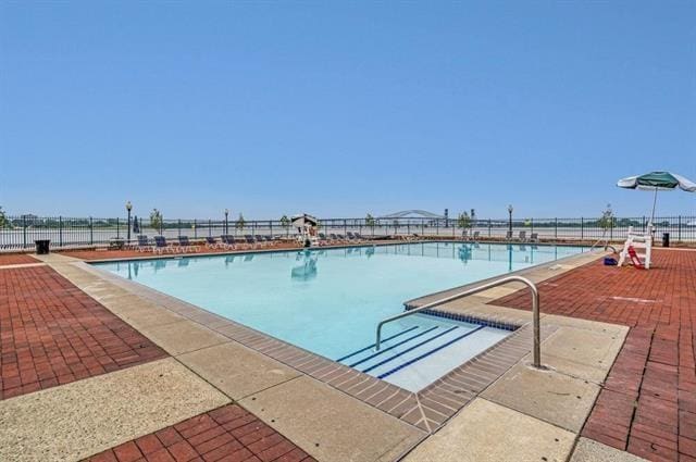 community pool featuring a patio area and fence