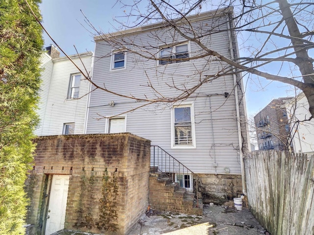 back of house featuring fence