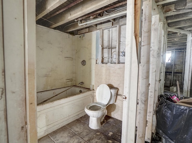 bathroom with tub / shower combination and toilet