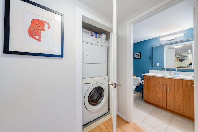 700 1st St Unit 11M, Hoboken, NJ 07030 - washroom featuring estacked washer and dryer and light tile patterned flooring