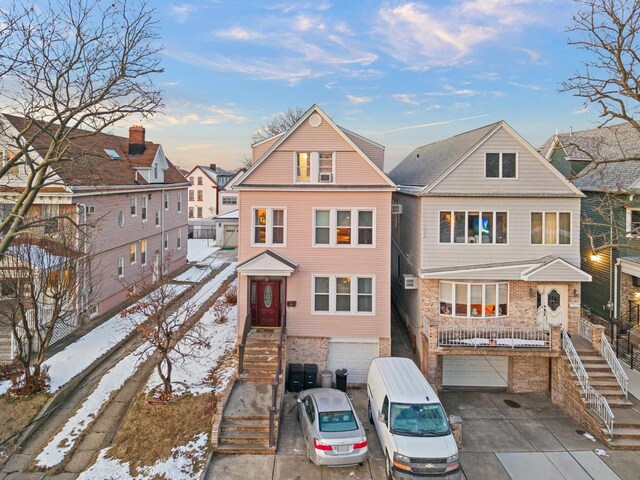 57 W 5th St, Bayonne, NJ 07002 - view of front of property featuring an attached garage, driveway, stairway, and brick siding