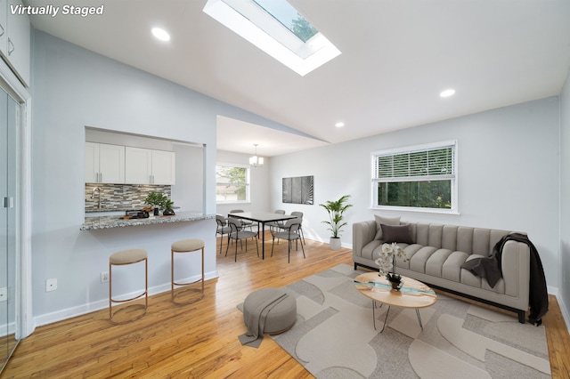 6715 Polk St Unit 12, Guttenberg, NJ 07093 - living area featuring light wood finished floors, lofted ceiling, recessed lighting, and a skylight