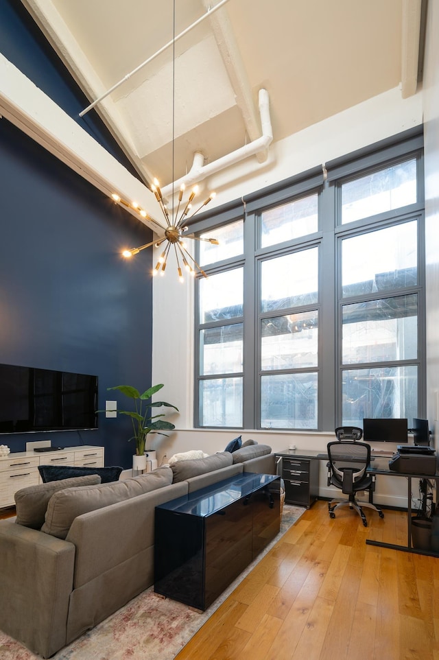 living room featuring an inviting chandelier and wood-type flooring