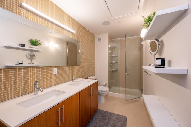 bathroom featuring toilet, a shower with shower door, tasteful backsplash, and vanity