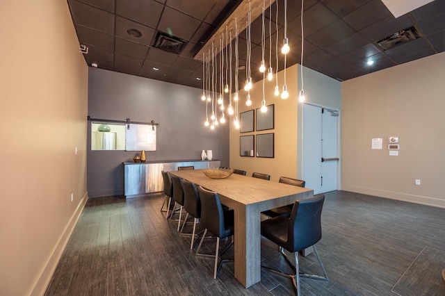 dining room with a paneled ceiling, dark wood-type flooring, and a high ceiling