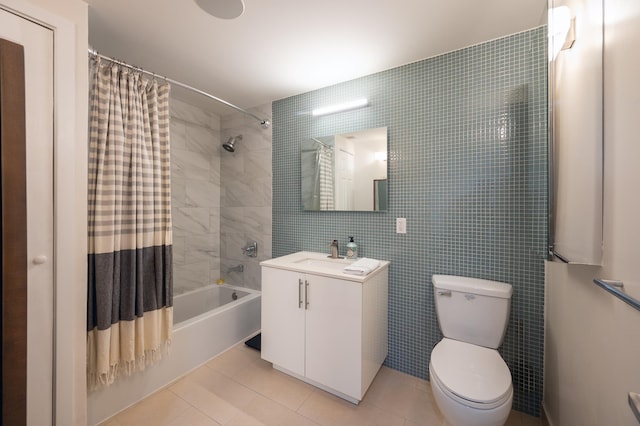 full bathroom with toilet, shower / bath combo, tile walls, tile patterned floors, and vanity